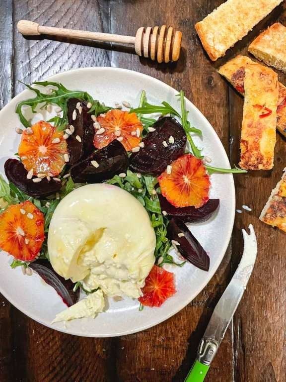 Beet and blood orange salad with creamy cheese and greens